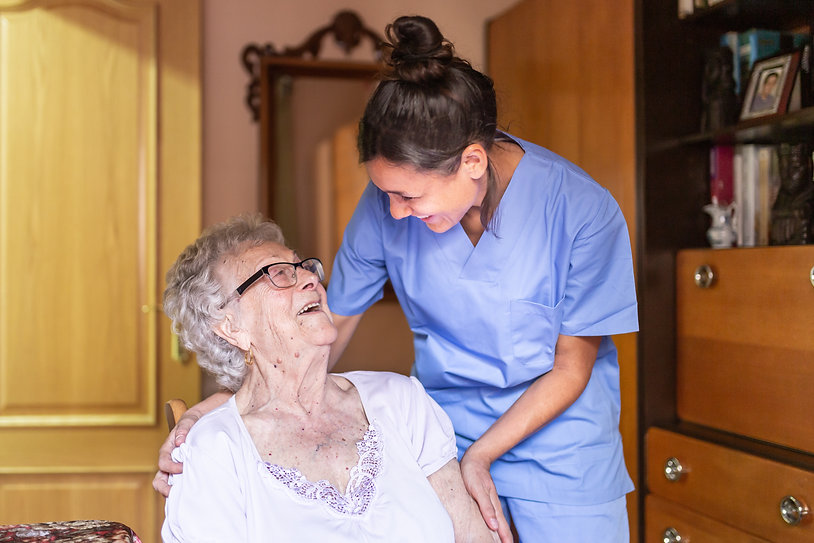 Medical nurse helping elderly woman at patients residence