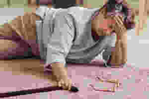 An elderly senior woman who has fallen down due to health risk factors and can't get up without help.