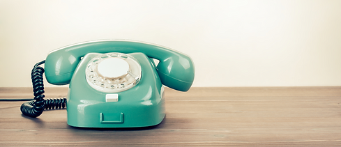 Retro rotary telephone on wood table_edited.png