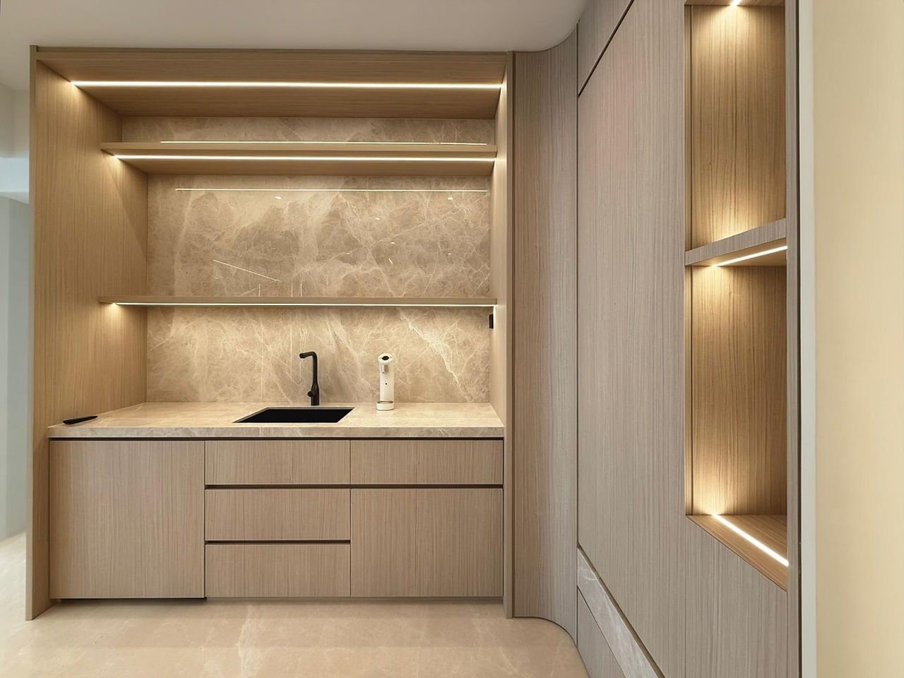 Custom dry pantry and display cabinetry at The Makena featuring timber finishes, stone surfaces and integrated ambient lighting