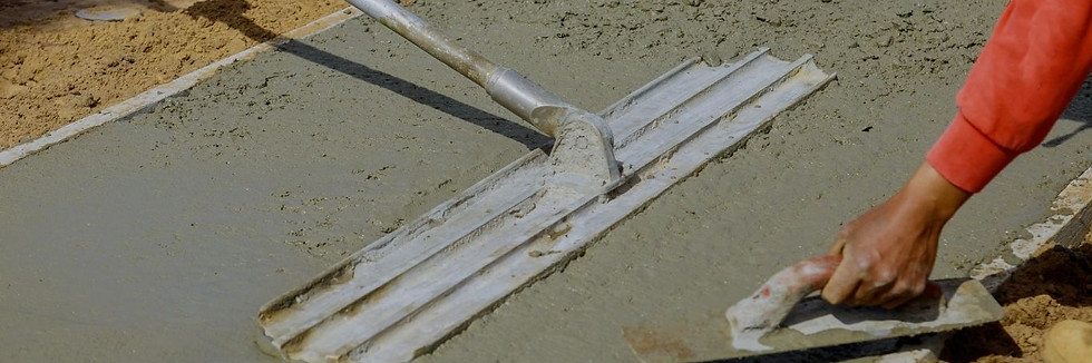 Concrete contractor in Garden Grove smoothing wet cement.