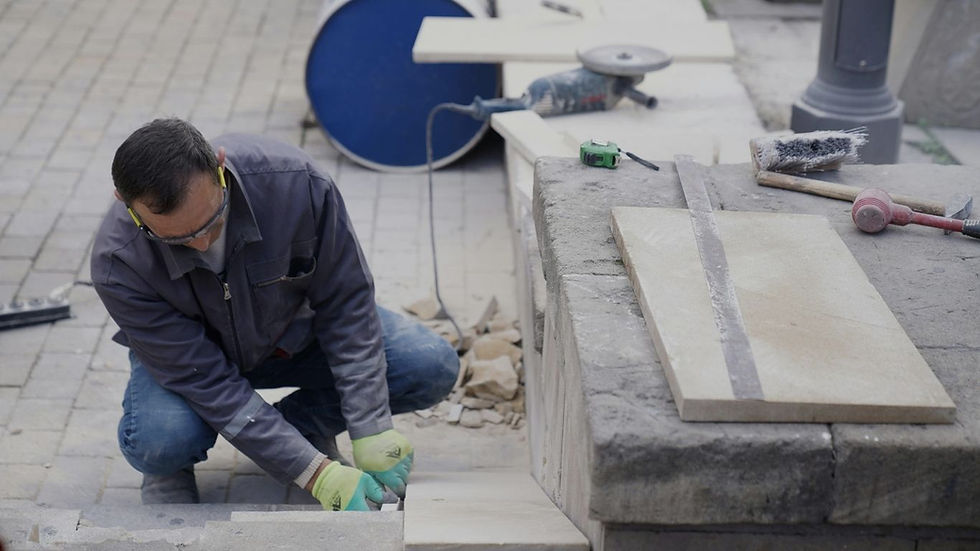 Commercial concrete contractors installing stone pavers.