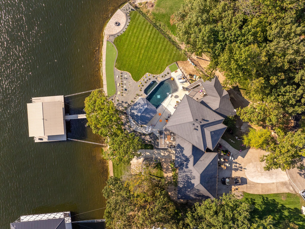 Drone image of lakefront home, highlighting landscaping