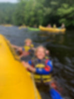 Mom and her son floating near an inflatable kayak on the Kennebec River in Maine.