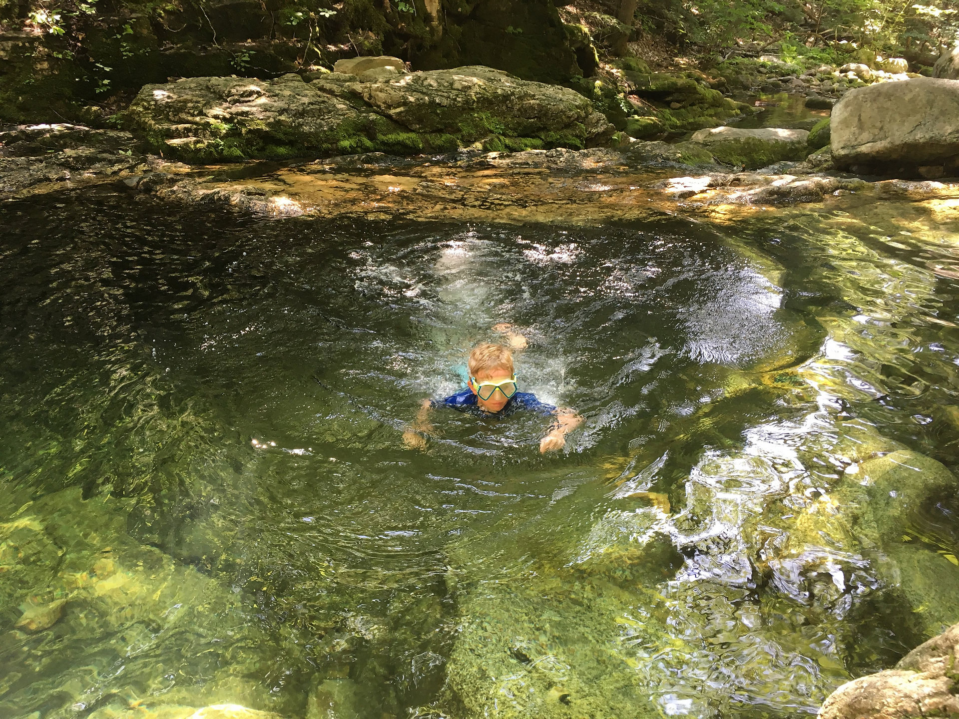 Boys swimming in Rattlesnake Pool at Blueberry Mountain in Maine