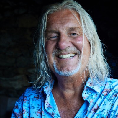 John Harvey - tanned and smiling, with shoulder length grey hair