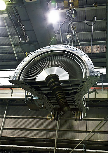 Shin Nippon Machinery API 612 steam turbine casing and rotor lifted by overhead crane during assembly