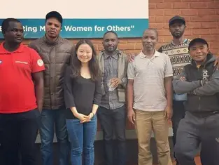 Photo of Jean Guo with a group of learners at Dzaleka refugee camp in Malawi during the launch of Konexio's pilot project in 2019.