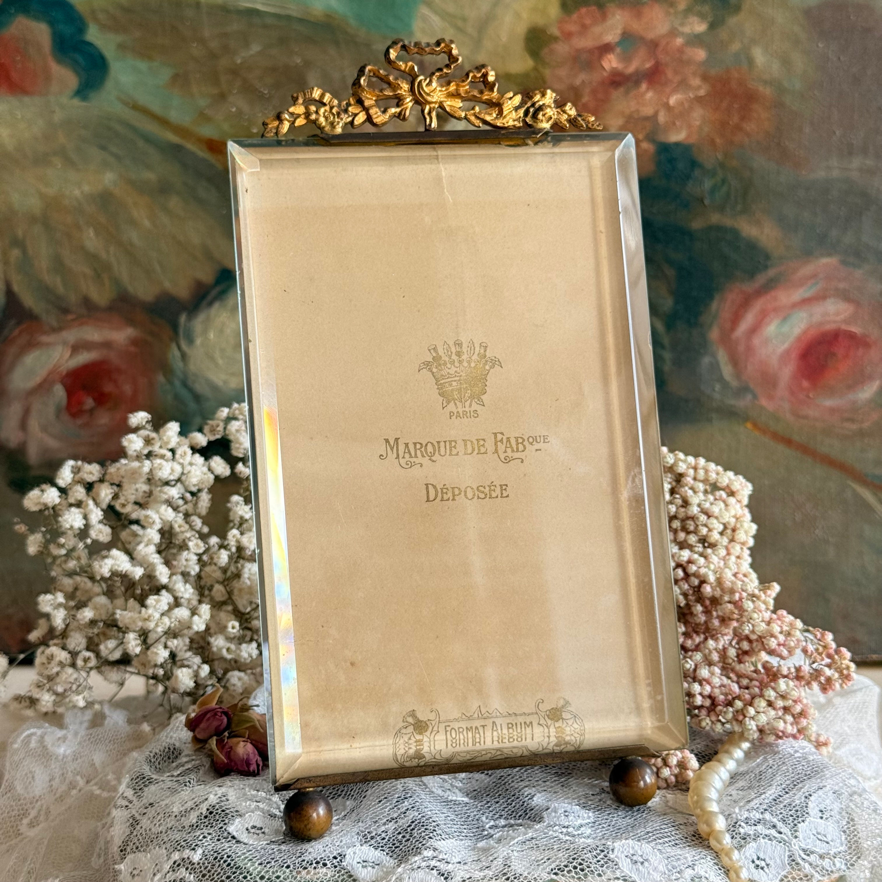 Antique ormolu and bevelled glass frame