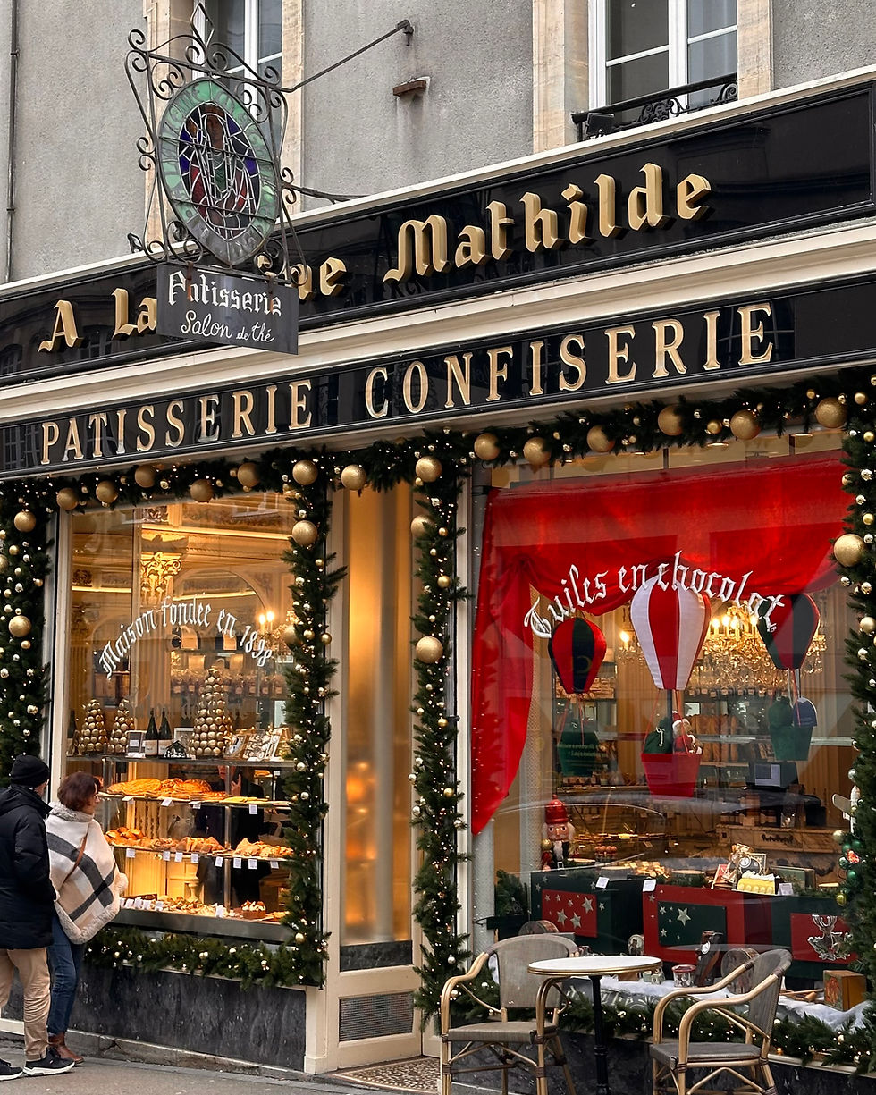 A bayeux old Patisserie window with macarons and patisserie