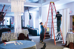 Joe Mineo Creative team work on pipe and draping.