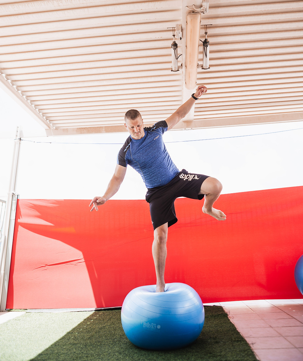 Yossi balancing on one leg on the ball