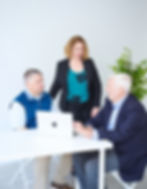 Thrivner employees discussing by a table