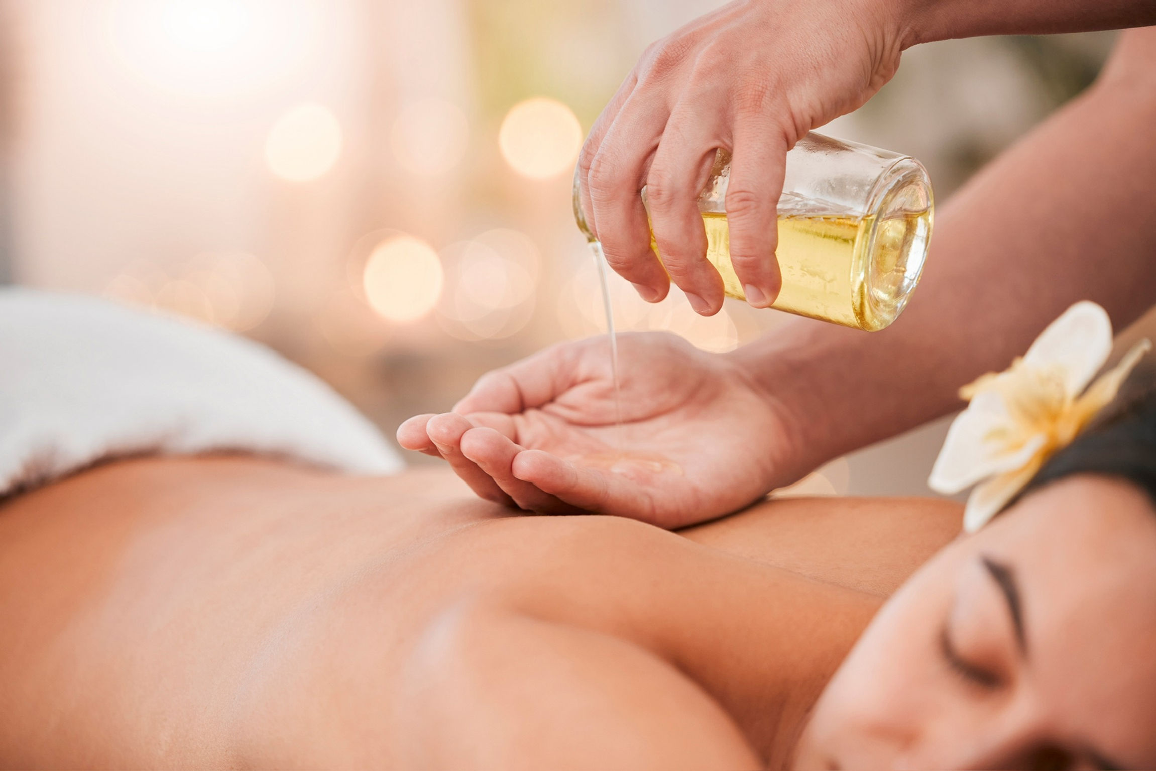 A massage therapist prepares oil at a massage spa