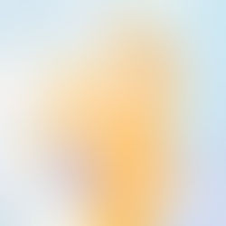 A pastel toned picture of a mum dancing with a baby in a carrier on her back