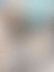 Woman walking in front of pastel buildings