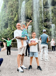 Man and kids at cloud forest waterfall