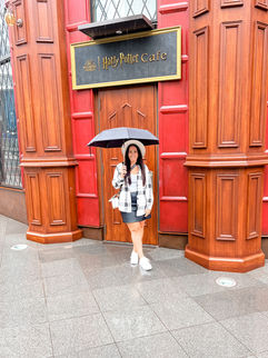 woman standing in front of harry potter cafe in tokyo