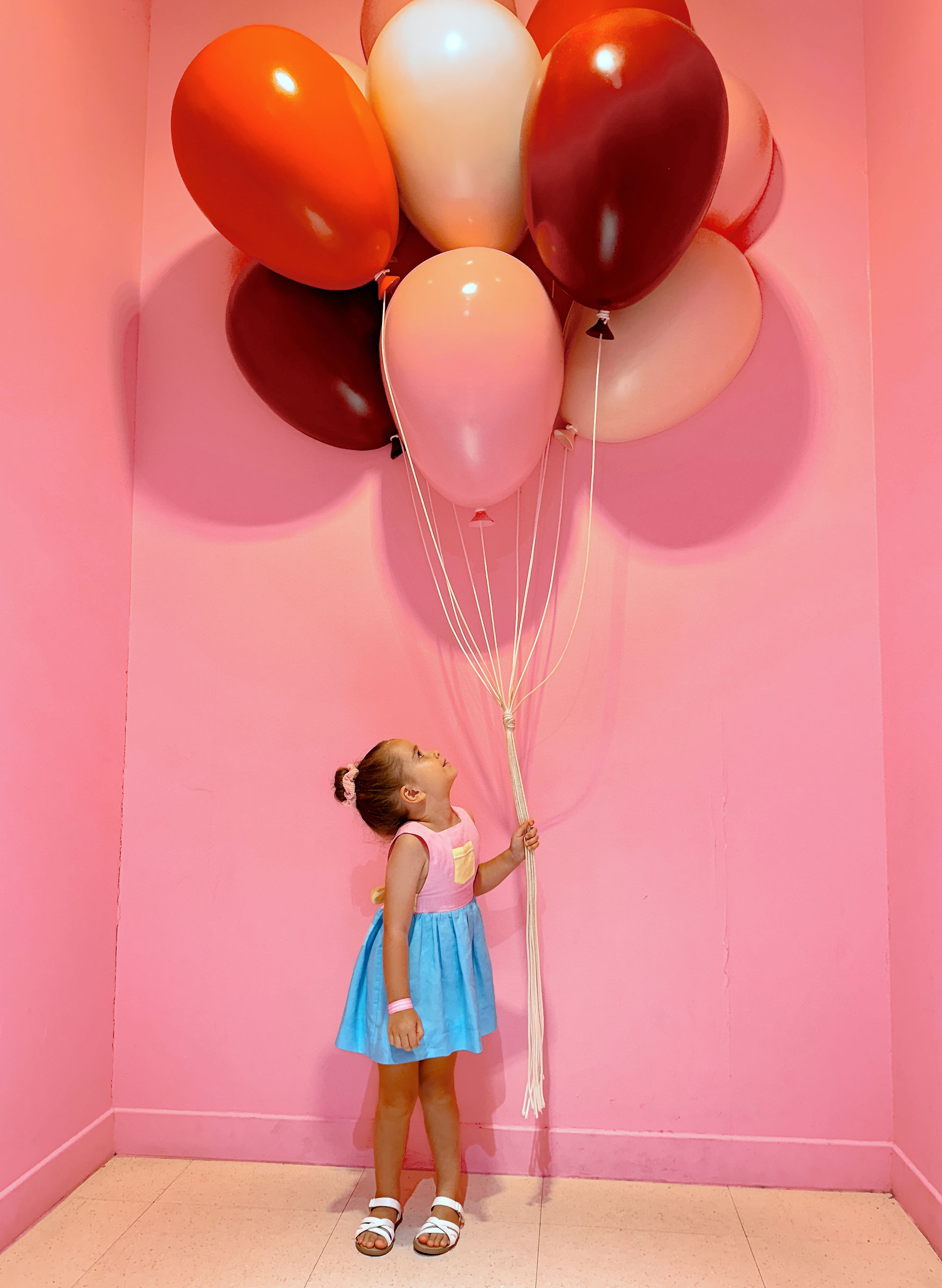 Girl Holding Balloons at Museum of Ice Cream
