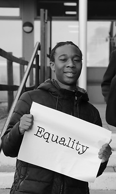 Falinge Park High School student holds sign reading 'Equality'