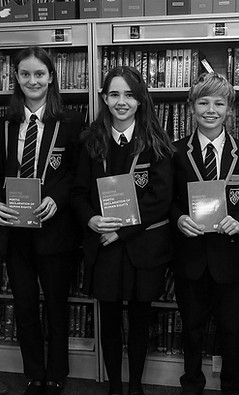 Stockport Grammar School teachers and students holding their copy of the Greater Manchester Poetic Declaration of Human Rights