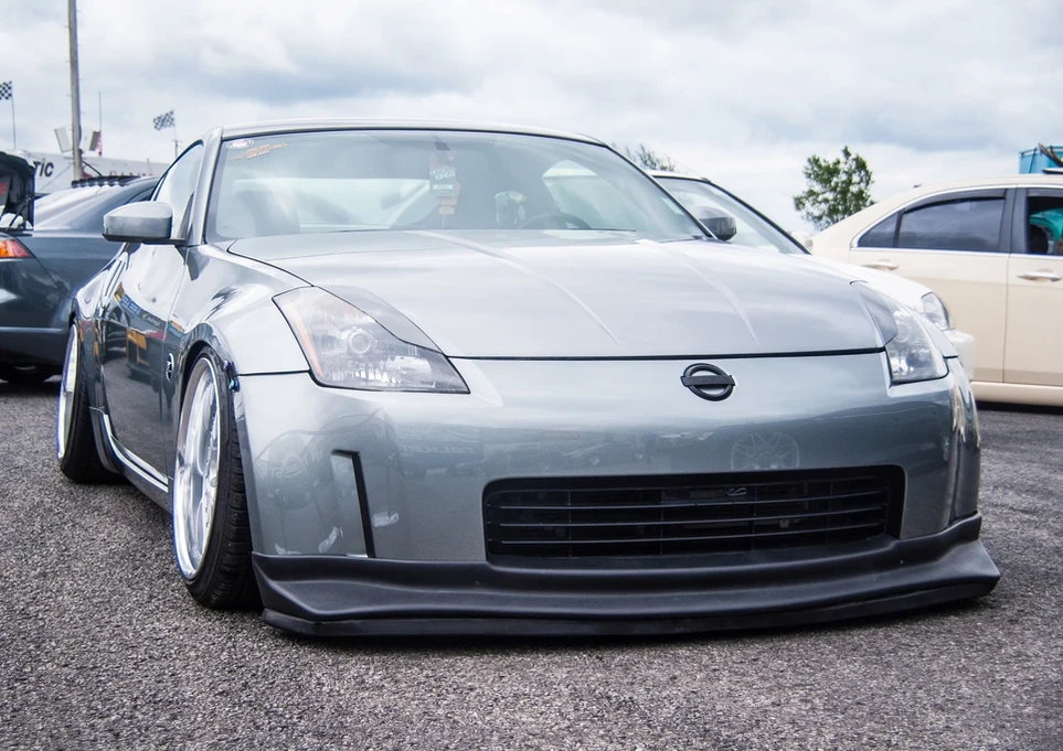 Silver Nissan 350Z sport car with low stance and dark front spoiler.