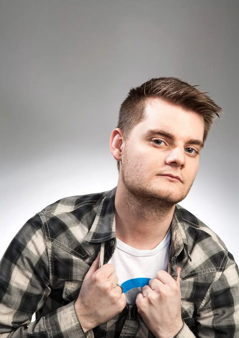 Traditional Portraits by Blake Ferguson Photography depicts a head and shoulders Image of a Male Model wearing plaid captured in the Studio.