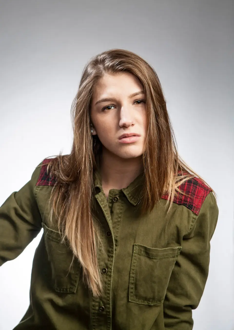 Traditional Portraits by Blake Ferguson Photography depicts a head and shoulders Image of a Female Model with a serious face captured in the Studio.