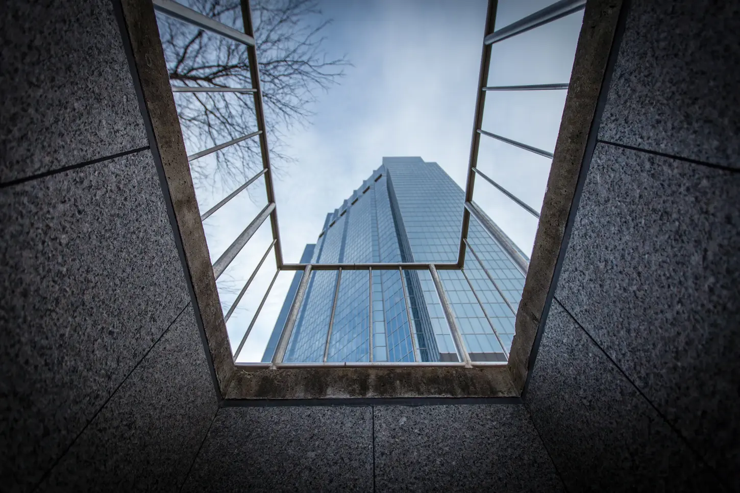 Cityscape & Street Fine-Art Photography by Blake Ferguson demonstrate looking up at One Dundas Place through a gated perspective in Downtown London, Ontario, Canada.