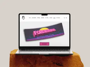 Graphic Design depicts the ForeverBroke Landing Screen on a MacBook Air displaying their newly acquired box-slap sticker bundle.