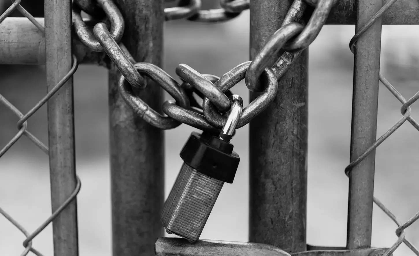 Cityscape & Street Fine-Art Photography by Blake Ferguson demonstrate a monochrome key-lock around a fence in Downtown London, Ontario, Canada.
