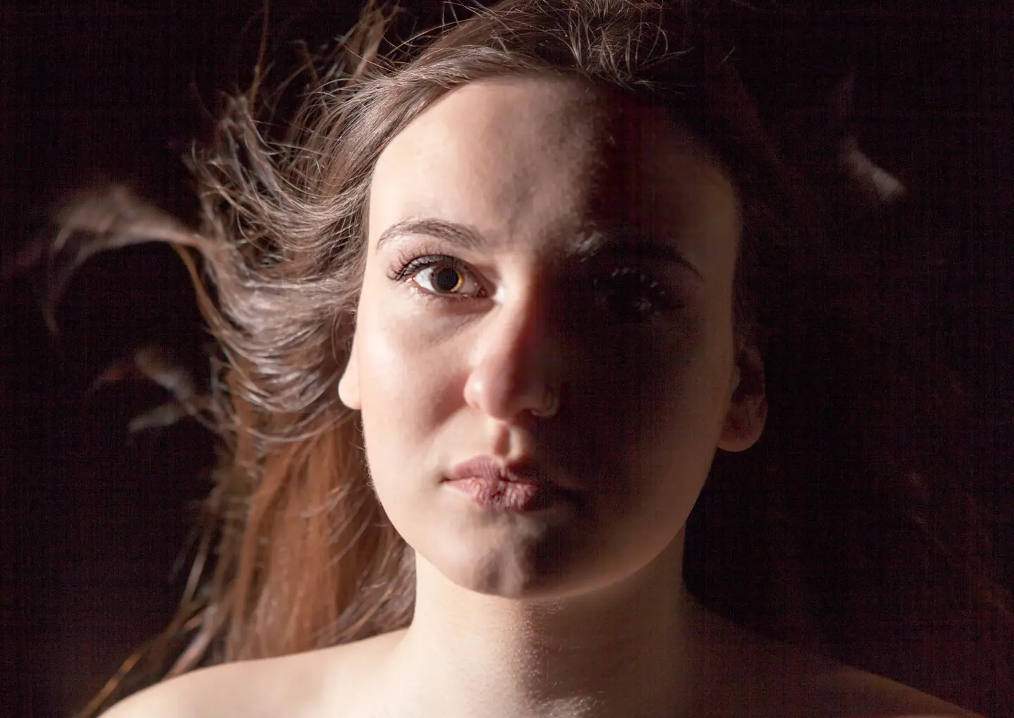Traditional Portraiture in Low-Key by Blake Ferguson Photography depicts a face only Image of a Female Model captured in the Studio.