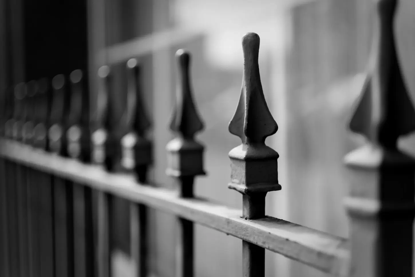 Cityscape & Street Fine-Art Photography by Blake Ferguson demonstrating a monochrome capture with shallow depth of field of a gothic fence in Downtown London, Ontario, Canada.