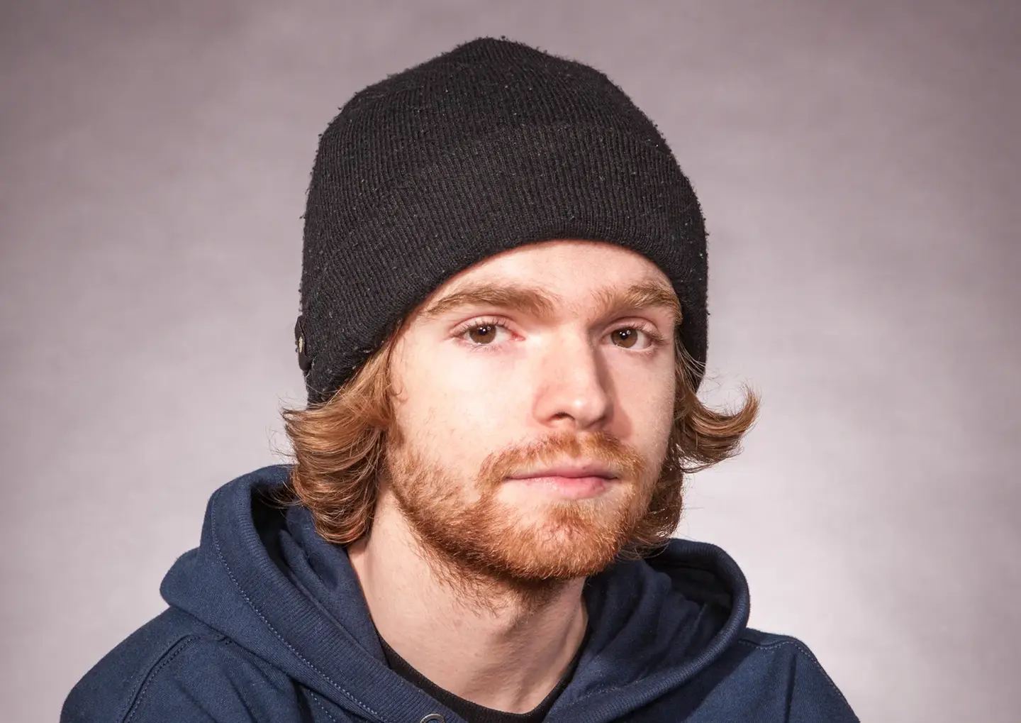 Traditional Portraits by Blake Ferguson Photography depicts a head and shoulders Image of a Male Model wearing a Vans sweater captured in the Studio.