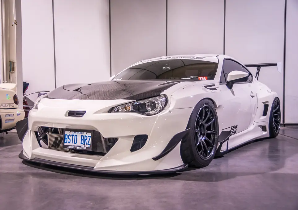 Modified white widebody sports car, QSTD 863 license plate, show display.