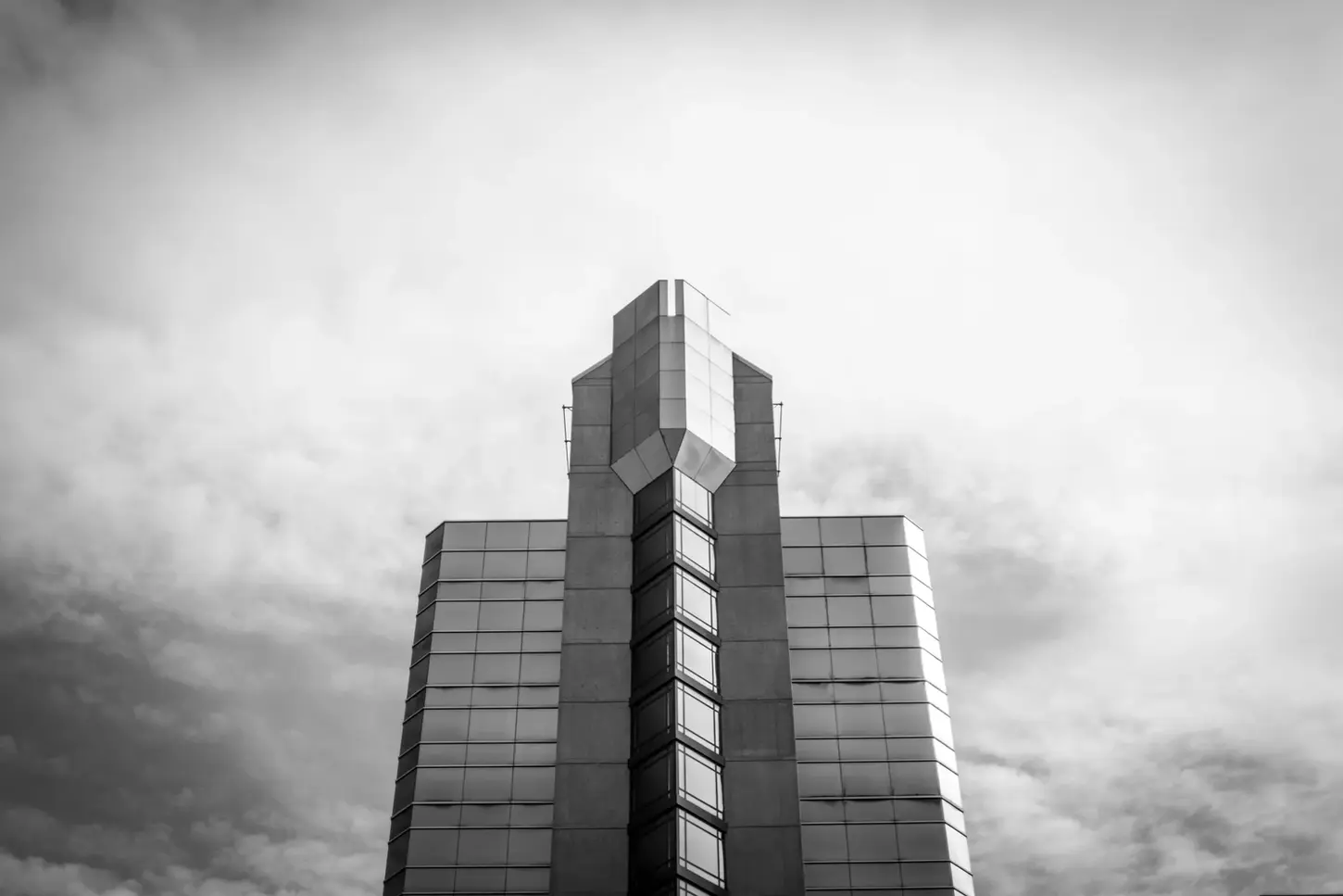 Cityscape in Monochrome Fine-Art Photography by Blake Ferguson depicts the top of a skyscraper from street level in London, Ontario, Canada.