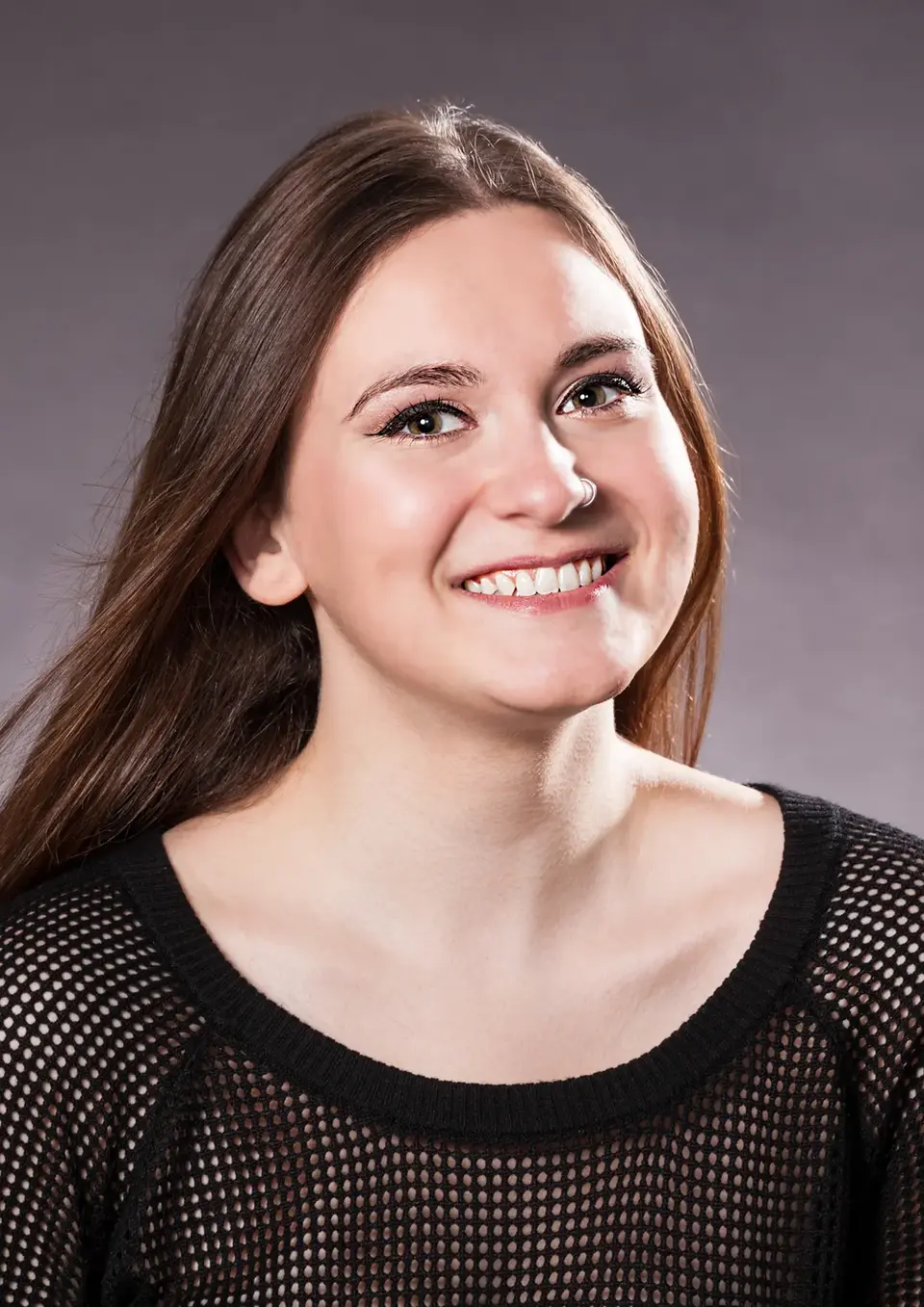 Traditional Portraiture in Low-Key by Blake Ferguson Photography depicts a head and shoulders Image of a Female Model smiling, captured in the Studio.