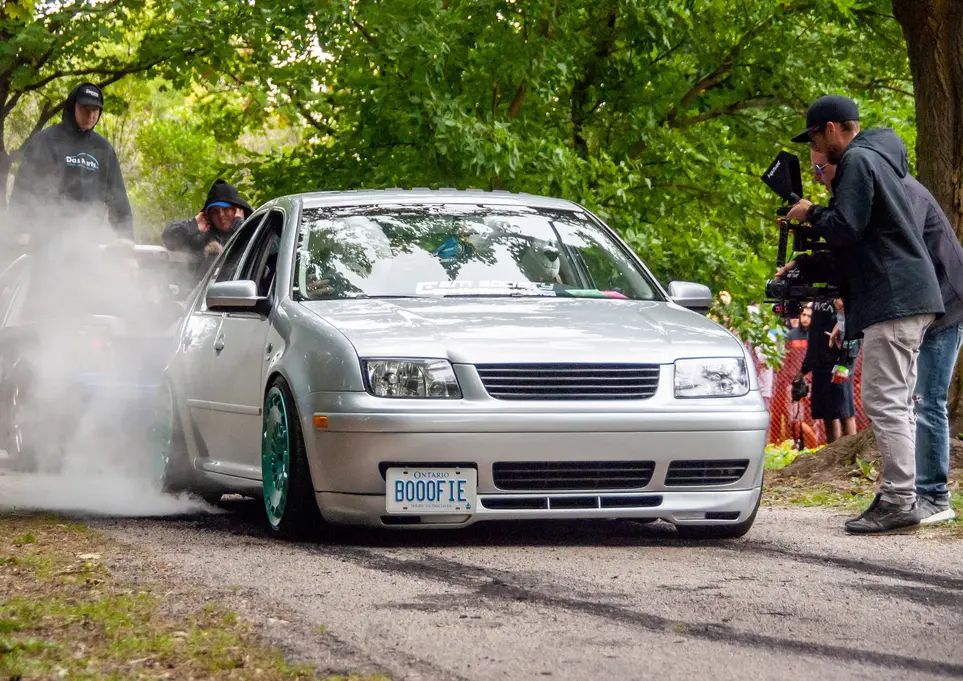 Silver car with smoke and license plate