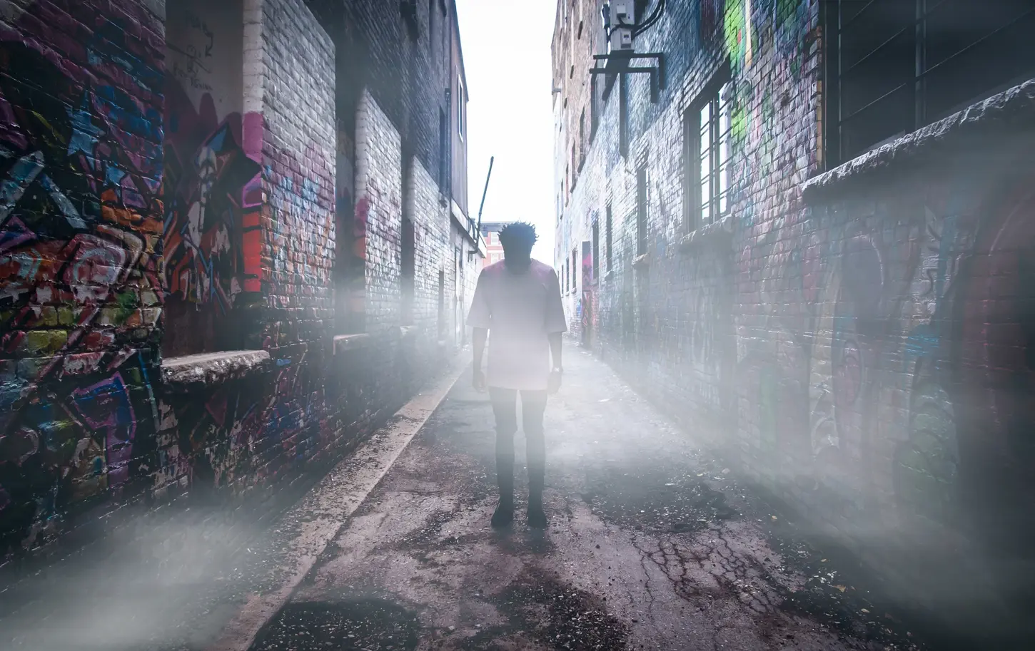Cityscape & Street Photography by Blake Ferguson showcase a hazy alleyway with a lone being in Downtown London, Ontario, Canada.