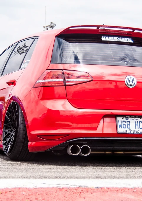 Red lowered Volkswagen Golf R hatchback, "WSC HCH" license plate.