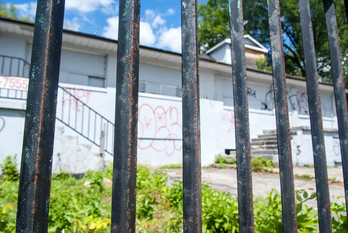 Cityscape & Street Fine-Art Photography by Blake Ferguson depict a fenced perspective of an Abandoned Building on Dundas Street, London, Ontario, Canada.