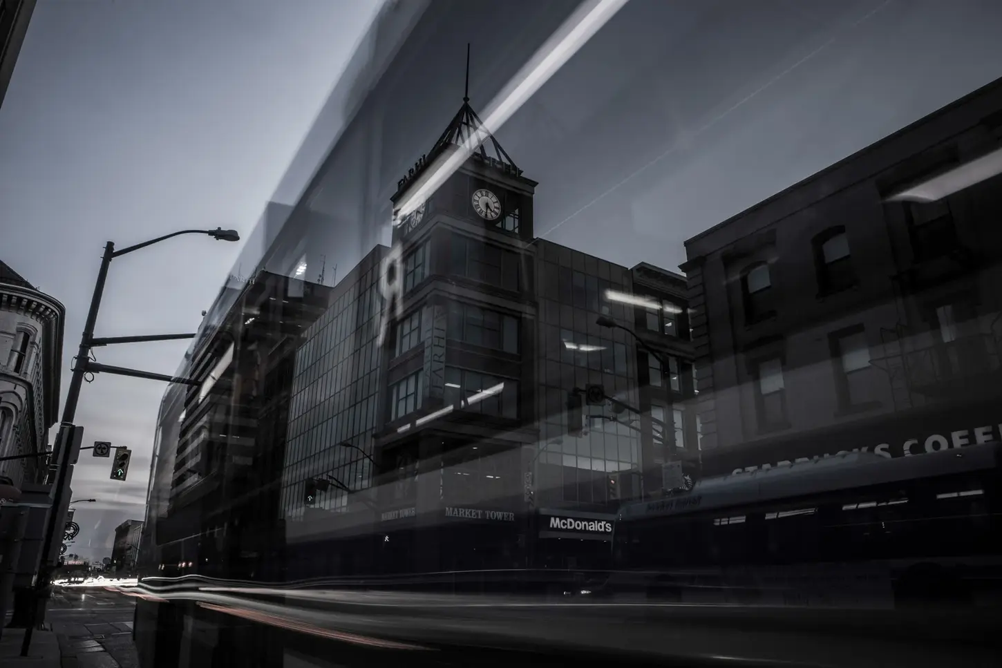 Cityscape & Street Fine-Art Photography by Blake Ferguson demonstrate a long-exposure of a bus passing by the Market Tower in Downtown London, Ontario, Canada.
