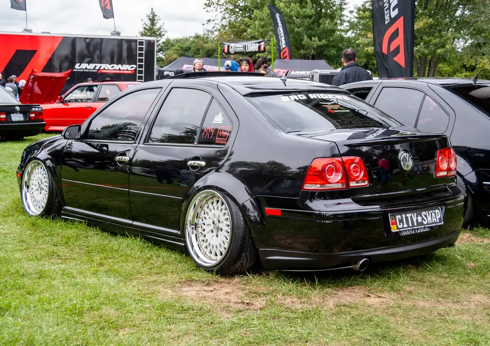 Black VW car with CITY-SWAP plate at a car show