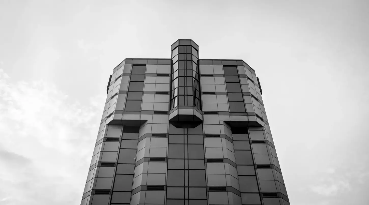 Cityscape in Monochrome Fine-Art Photography by Blake Ferguson depicts the top of a skyscraper from street level in Niagara Falls, Ontario, Canada.