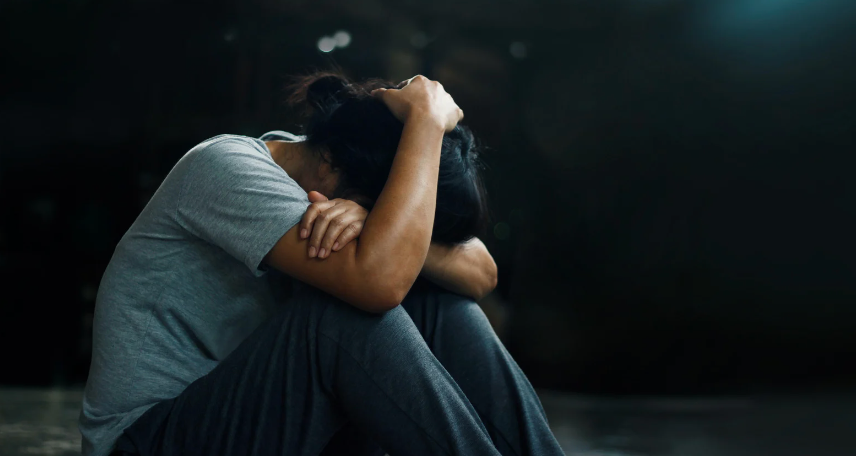 A person holding their head in their hands