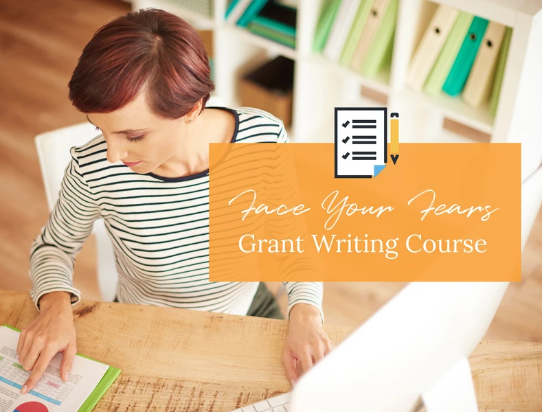 a woman sits at a desk with a sign that says face your fear grant writing courses