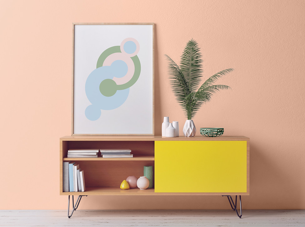 Low cabinet with short hairpin legs, sliding yellow door, white vase with verns, peach wall color, abstract framed art, trio of white ceramic low vases.