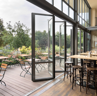 Green Mainland luxury folding glass doors opening onto a Dallas restaurant outdoor patio