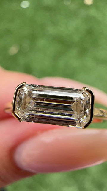 Thumbnail: 0.91 carat E SI2 east west emerald cut natural diamond half bezel solitaire 
