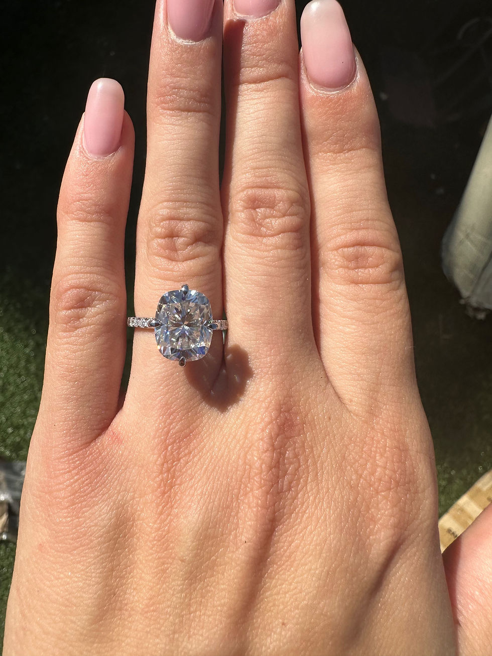 Thumbnail: 4.5 carat cushion moissanite with compass prongs on a pavé band 